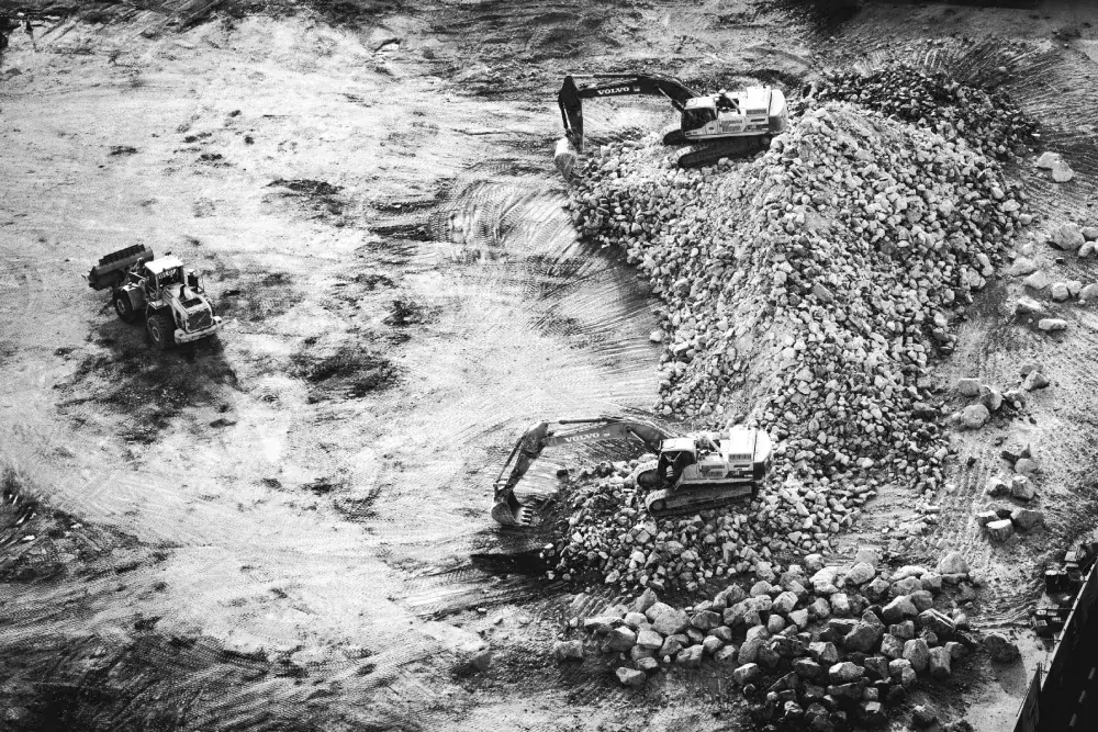 Aerial view of equipment working a quarry stockpile